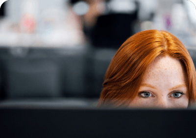 A close-up of a person focusing intently on a computer screen.